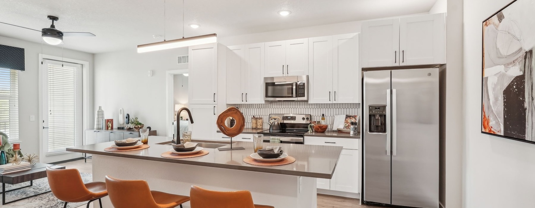 a kitchen with an island and chairs