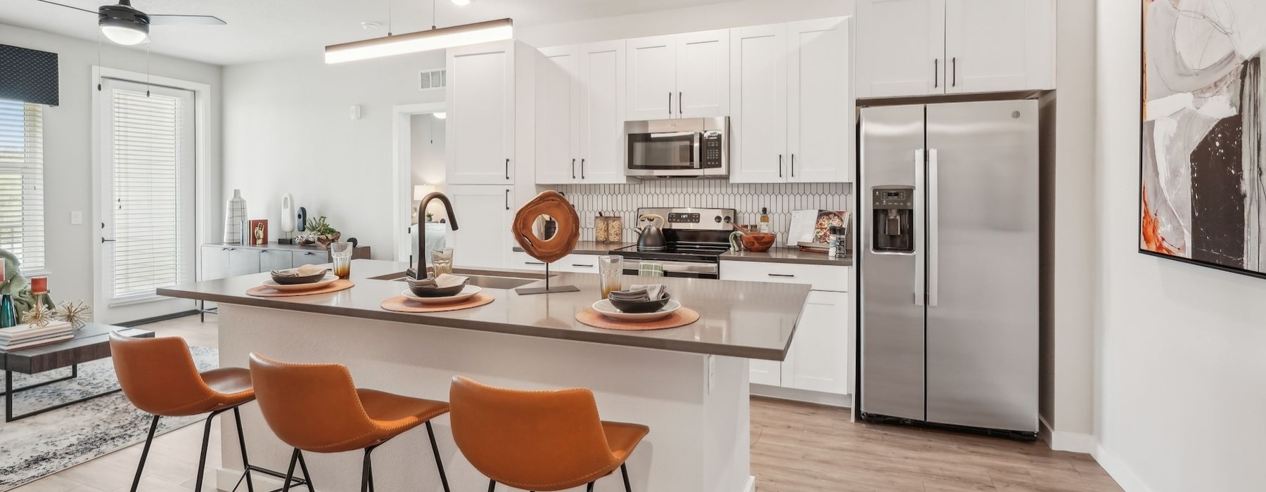 a kitchen with an island and chairs