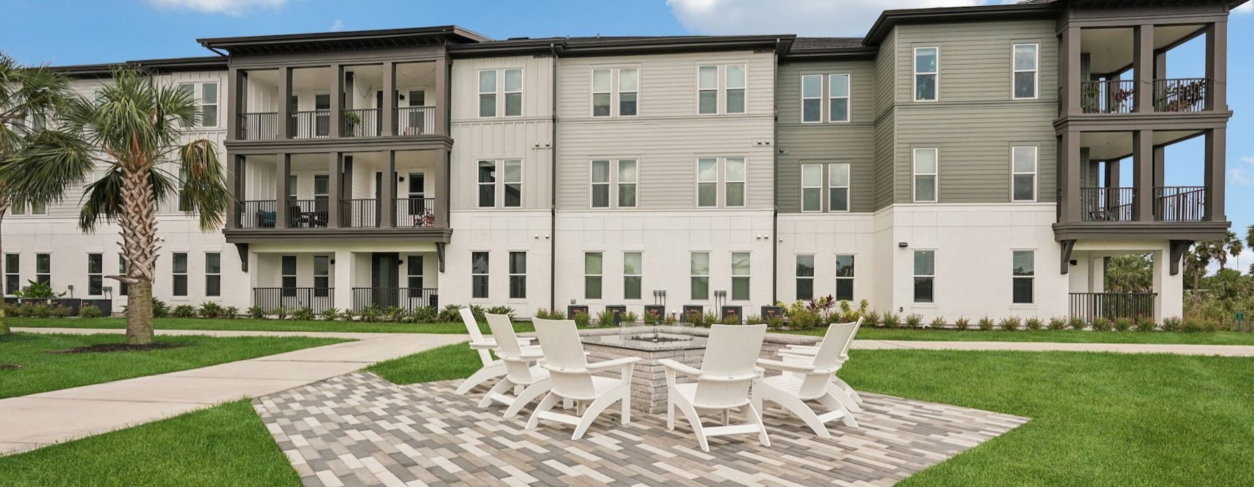 a building with a lawn and chairs in front of it