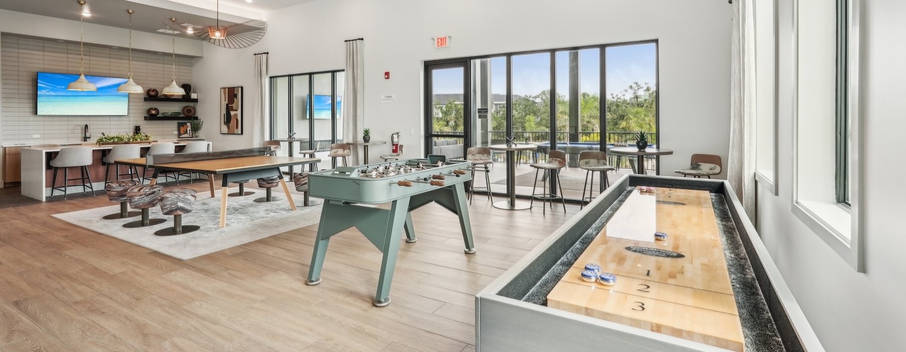 a game room with tables and chairs