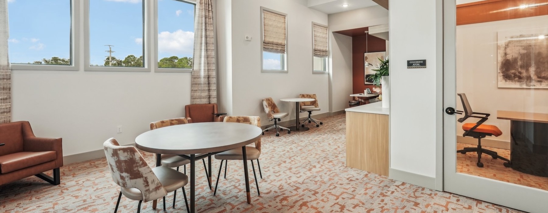 a clubroom with tables and chairs