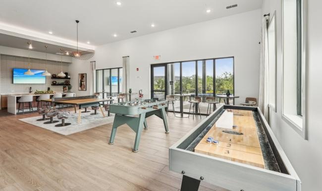 a game room with tables and chairs